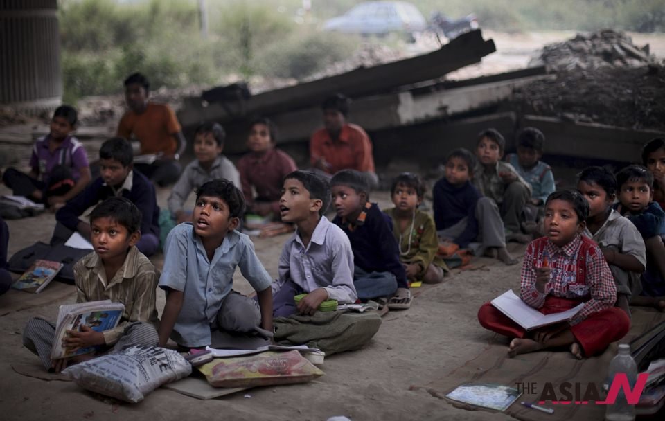 Children study amid vehicles and dogs in this school of MP